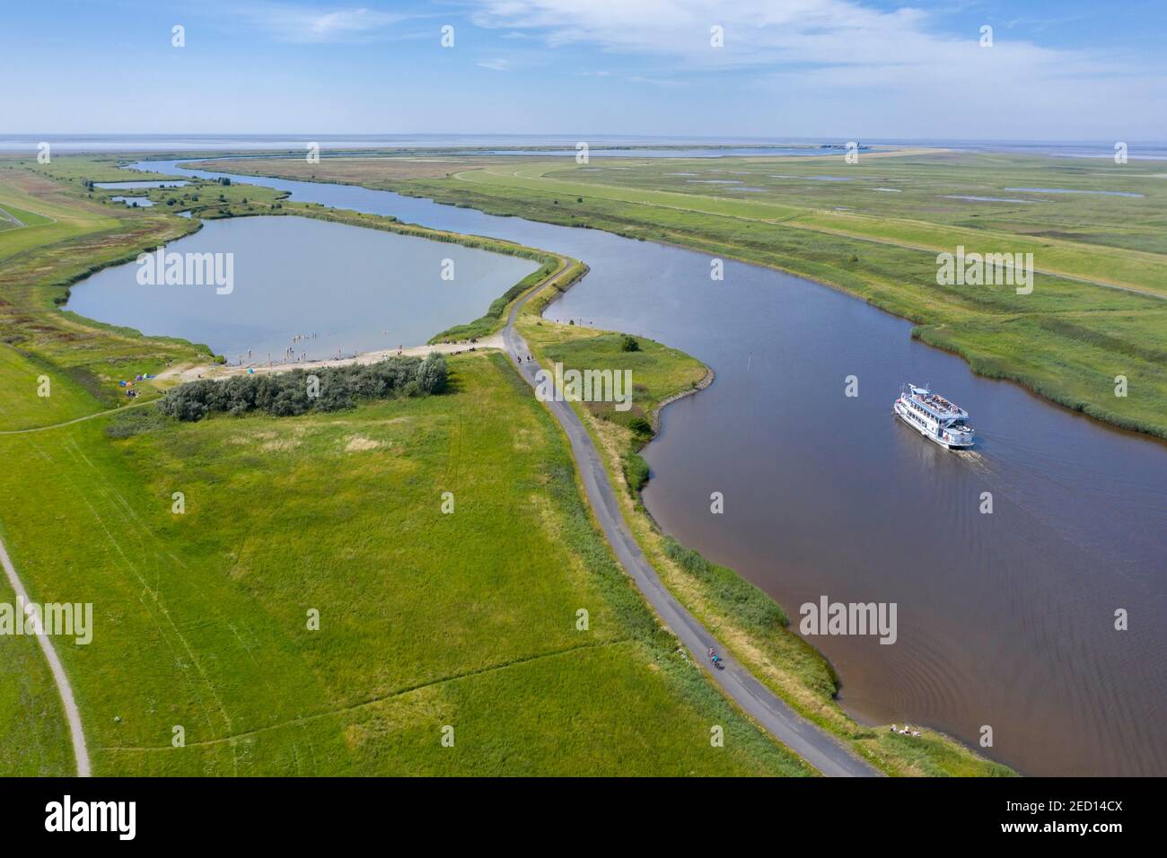 Drone shot with landscape at the Leyhoerner-Sieltief and tourist ship, Greetsiel, Lower Saxony, Germany Stock Photo