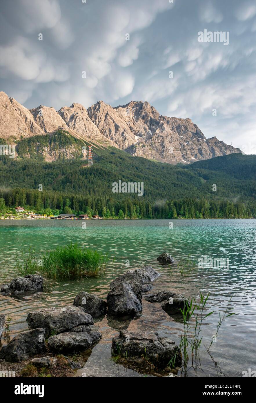 Rocks on the shore, Lake Eibsee lake in front of Zugspitze massif with ...
