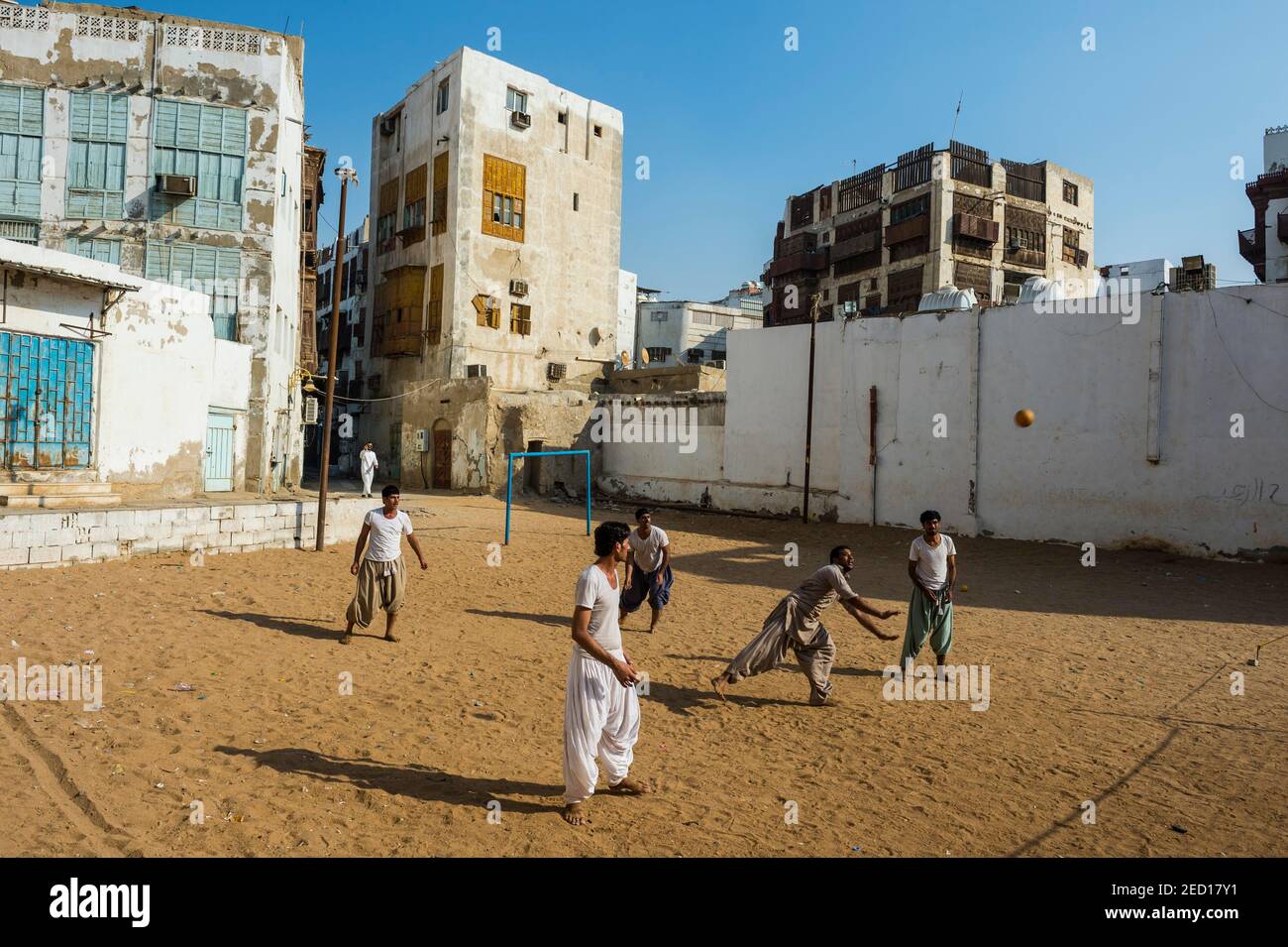Men playing volleyball in the old town of Jeddah, Saudi Arabia Stock