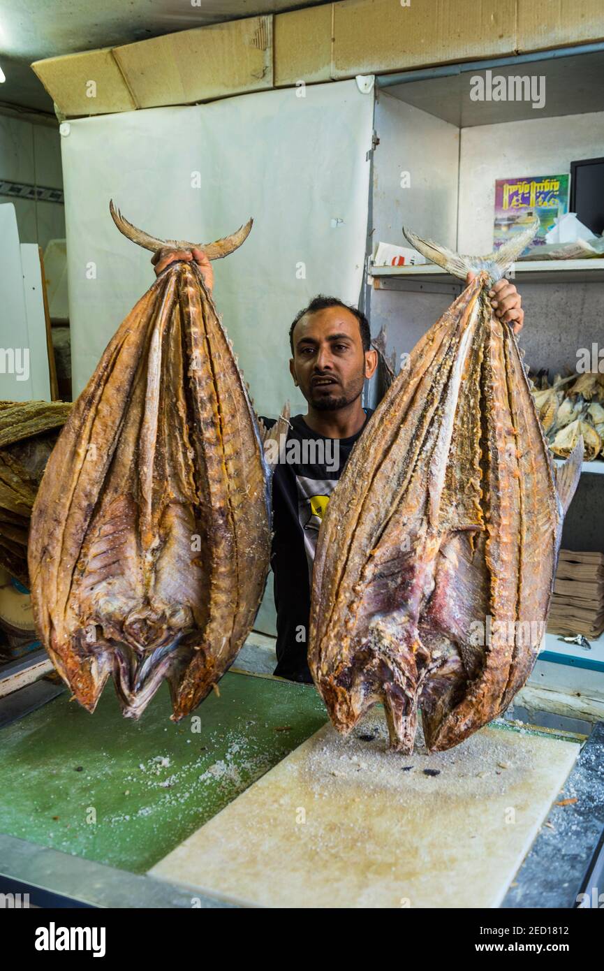 Man selling a huge dried fish, Jemenite market, Jeddah, Saudi Arabia Stock Photo