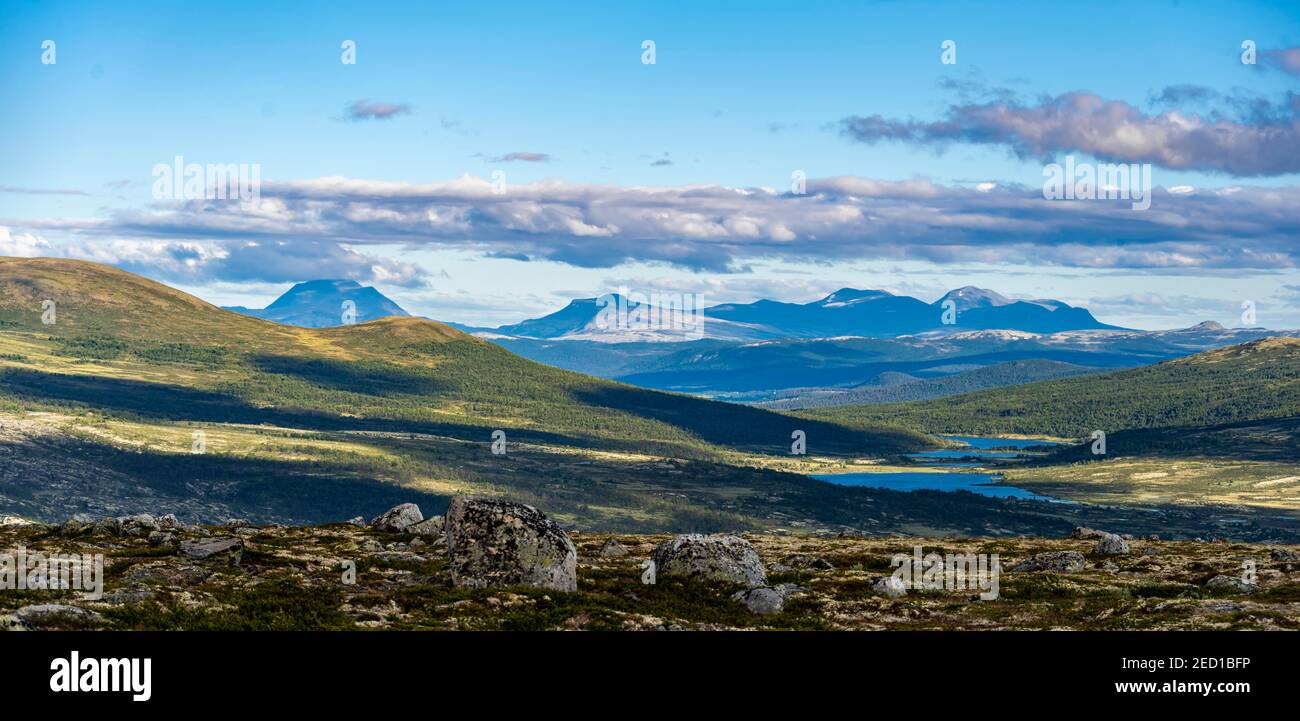 lakes-in-the-tundra-barren-landscape-mountains-in-the-background