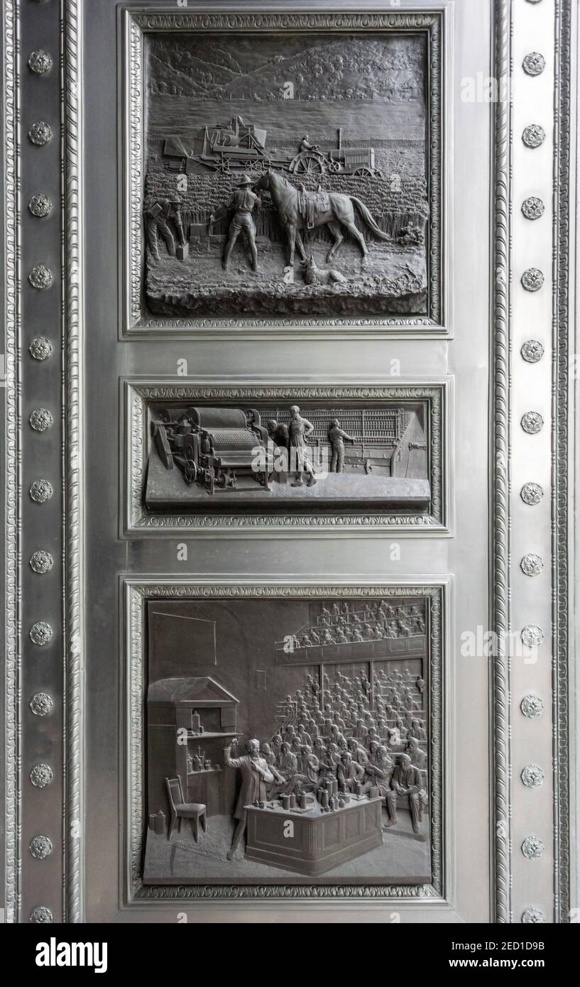 Bas Reliefs on Door, by William Bateman Fagan (1860-1948), in the city of London, UK Stock Photo