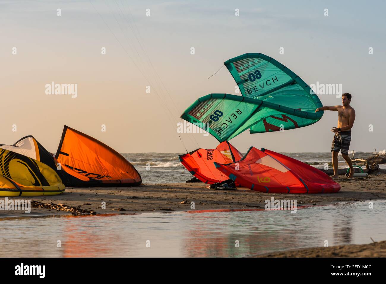Kitesurfing beach, kiteboarding sport, kites n the beach and in the air