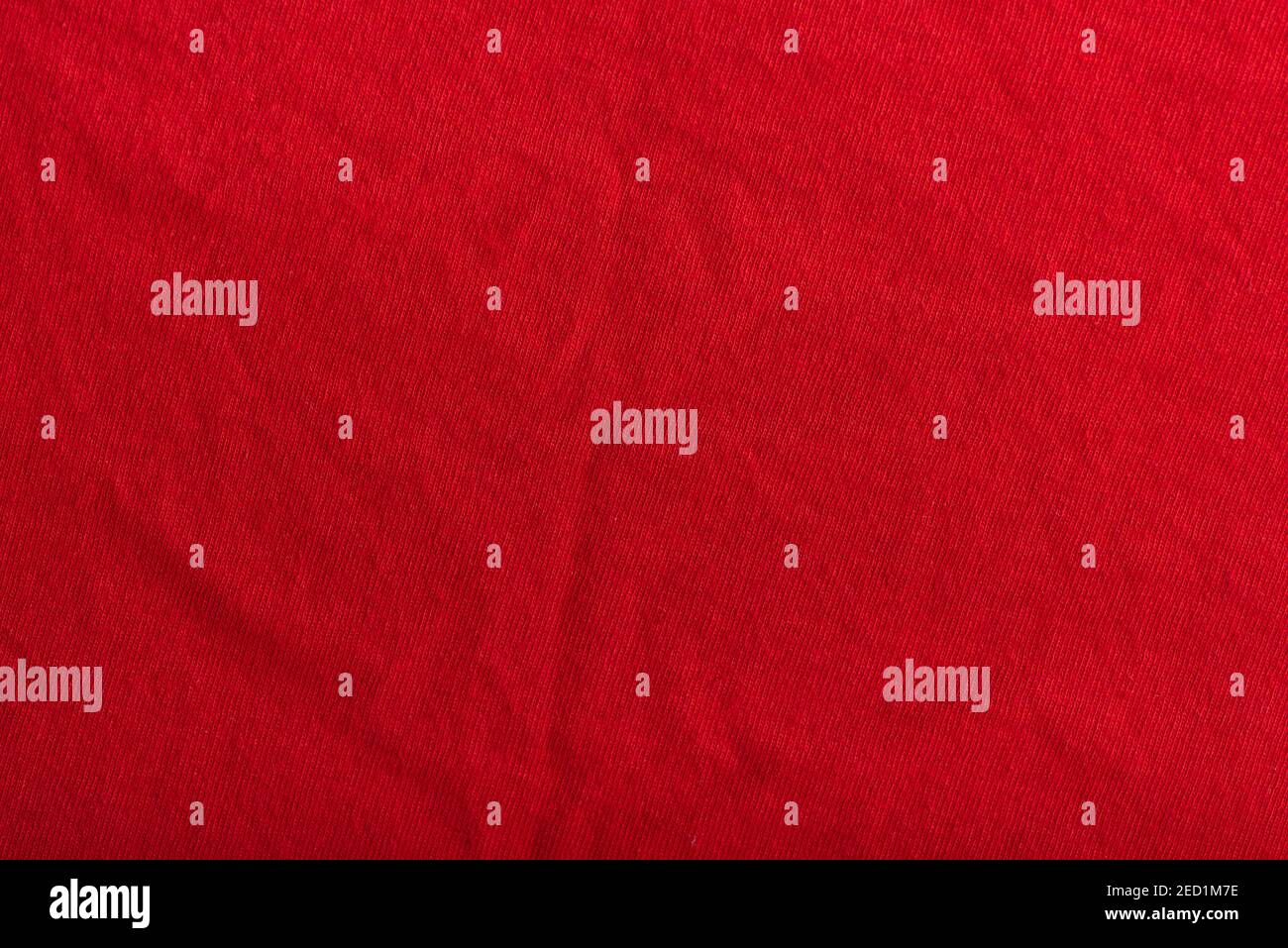 Red textured fabric with pleats. Woolen material. Stock Photo