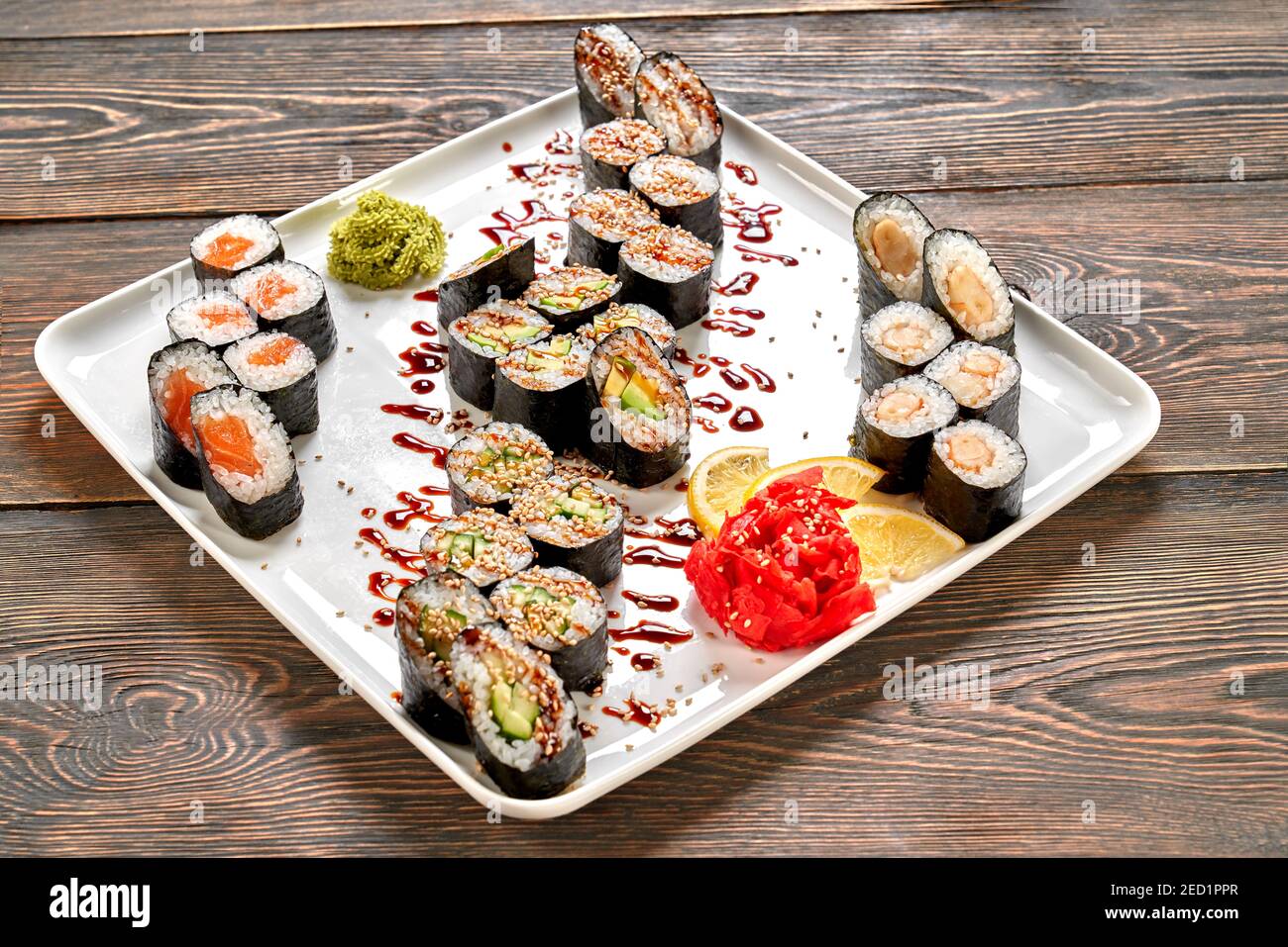 Japanese maki set presented on white plate. Sake maki, kappa maki, avocado  maki, tuna maki decorated with unagi sauce and sesame, lemon, wasabi, pickl  Stock Photo - Alamy