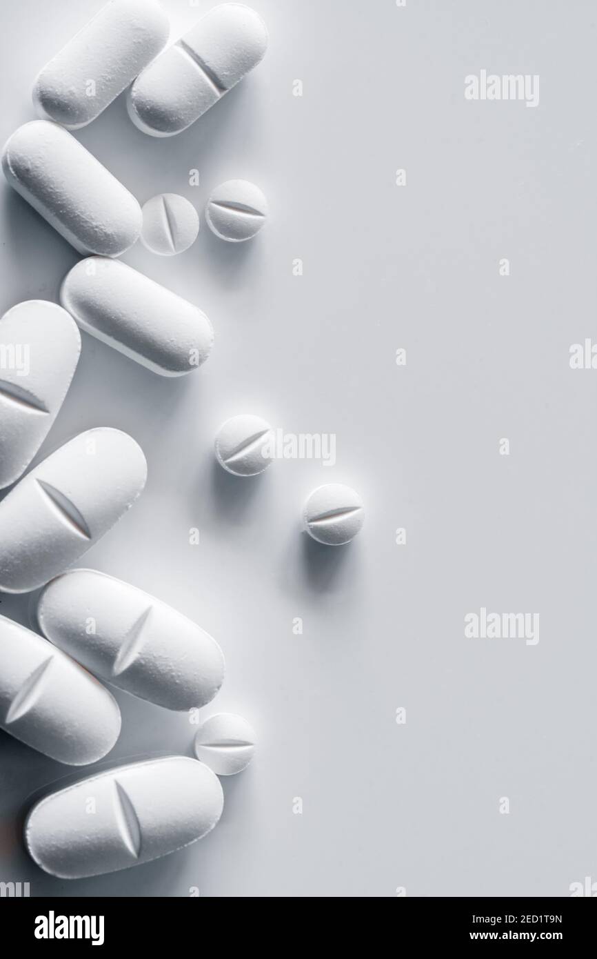 Top view of assorted white pills placed on white table Stock Photo