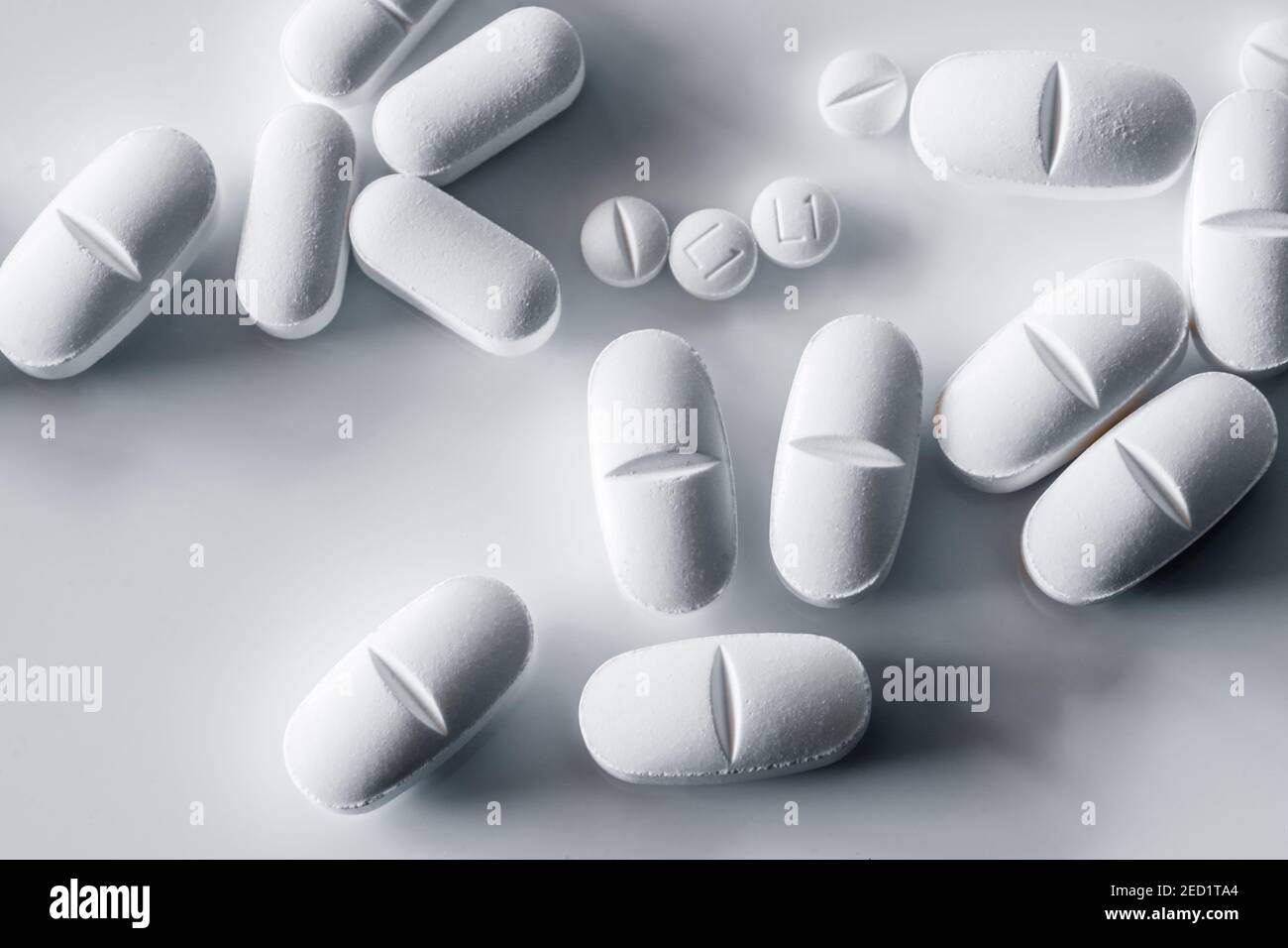 Top view of assorted white pills placed on white table Stock Photo
