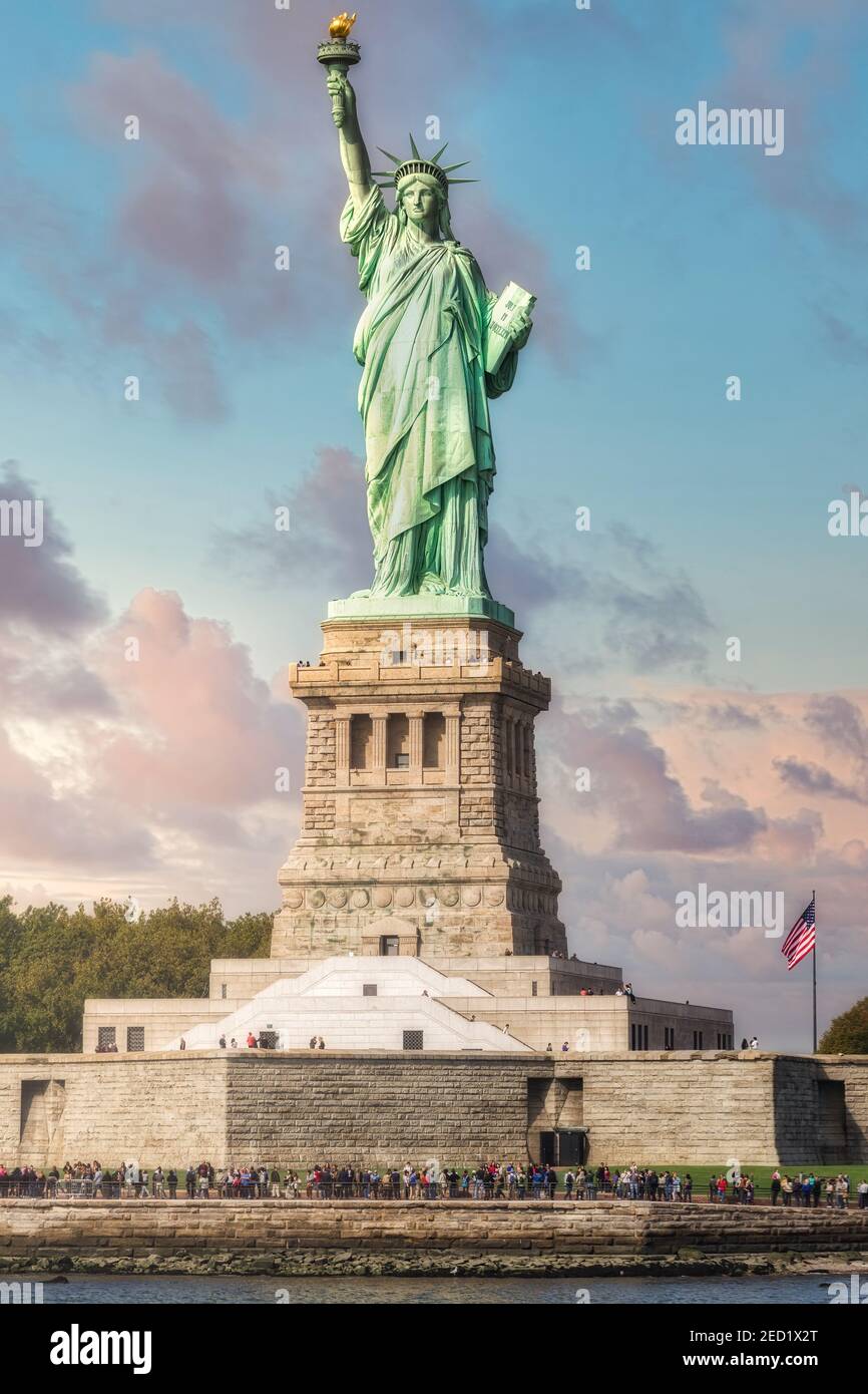 Statue of Liberty located on Liberty Island in New York against blue cloudy sky Stock Photo