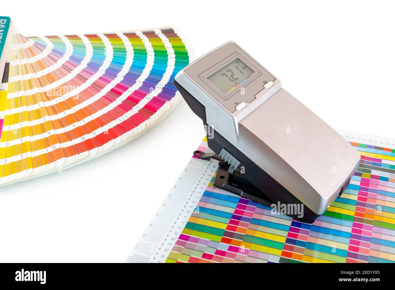 Printed color swatch, density meter and paint guide isolated on white background - clipping path. Measuring density of magenta color in printing proce Stock Photo