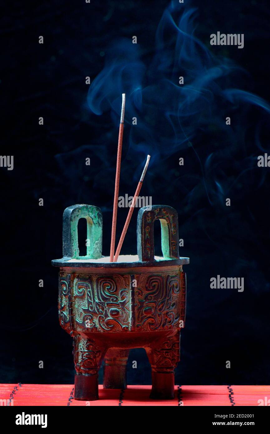Incense burner with burning incense sticks Stock Photo Alamy