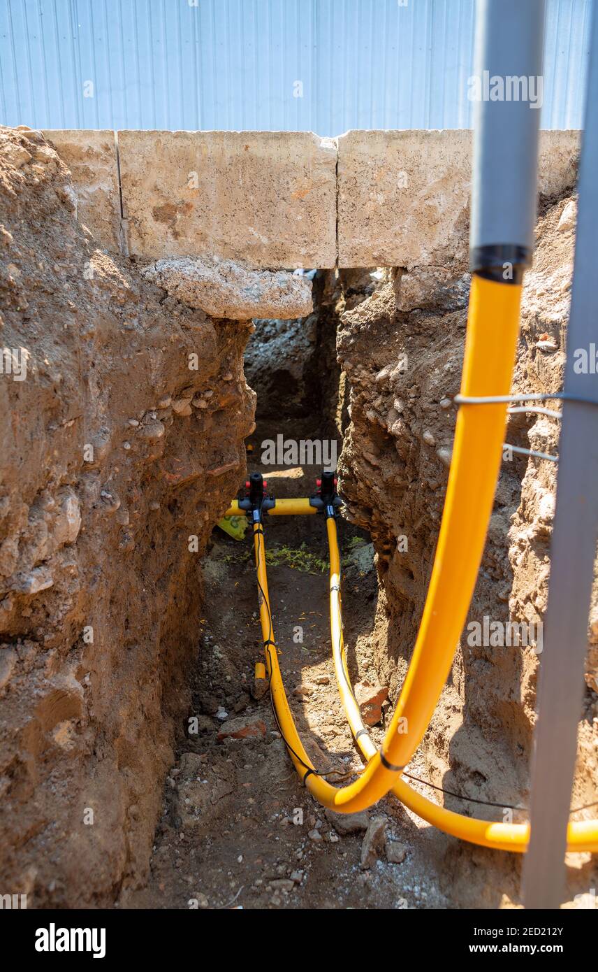 Main gas pipe and two connections with signal cables connected using fittings for electrofusion