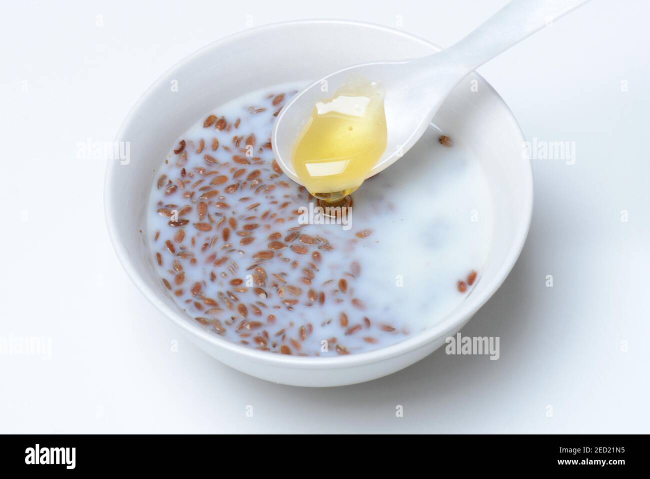 Bowl of swollen flax seed and spoonful of honey, flax swollen in water