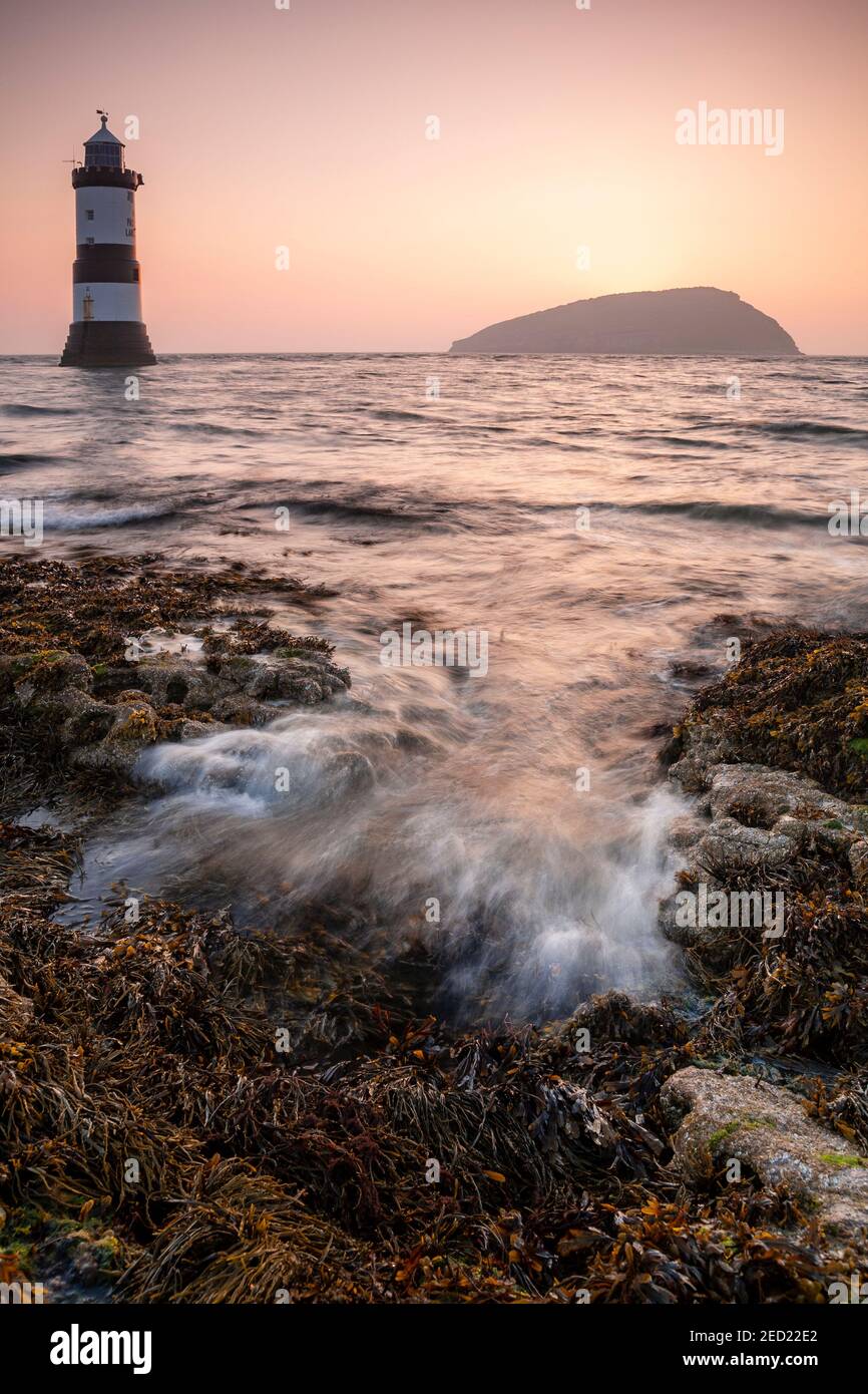 Penmon Point lighthouse and Puffin Island at sunrise, Anglesey, North Wales Stock Photo