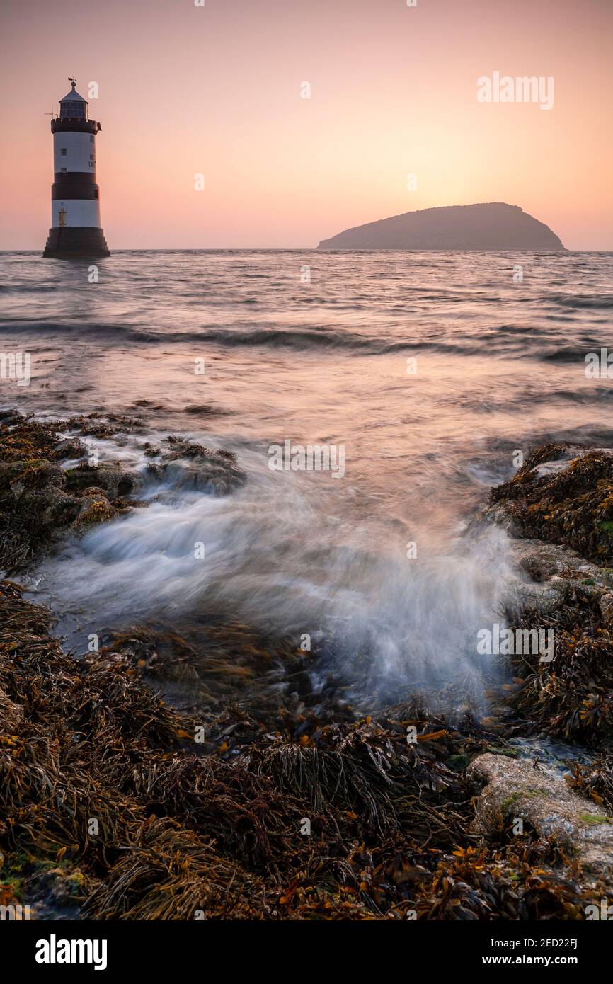 Penmon Point lighthouse and Puffin Island at sunrise, Anglesey, North Wales Stock Photo