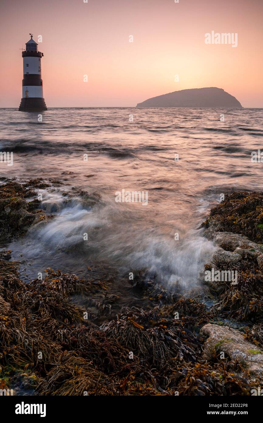 Penmon Point lighthouse and Puffin Island at sunrise, Anglesey, North Wales Stock Photo