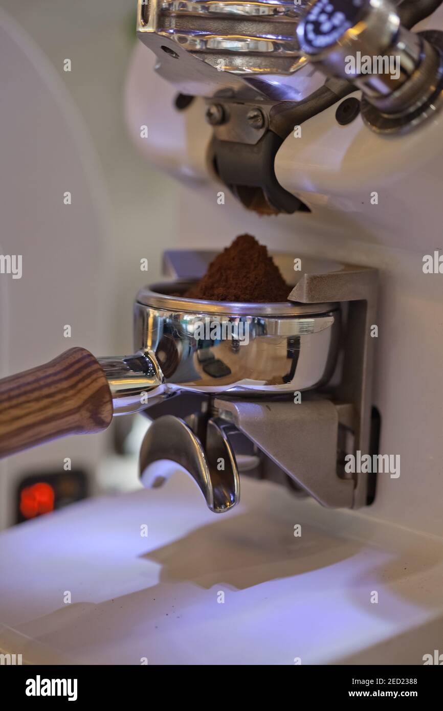 macro of ground coffee in espresso holder, modern grinder, closeup Stock Photo