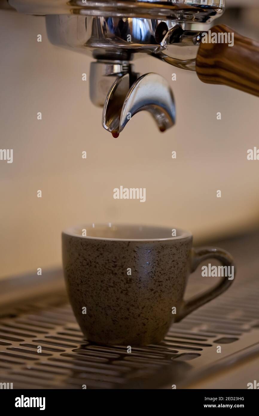 espresso coffee pouring into ceramic cup, closeup, nobody Stock Photo