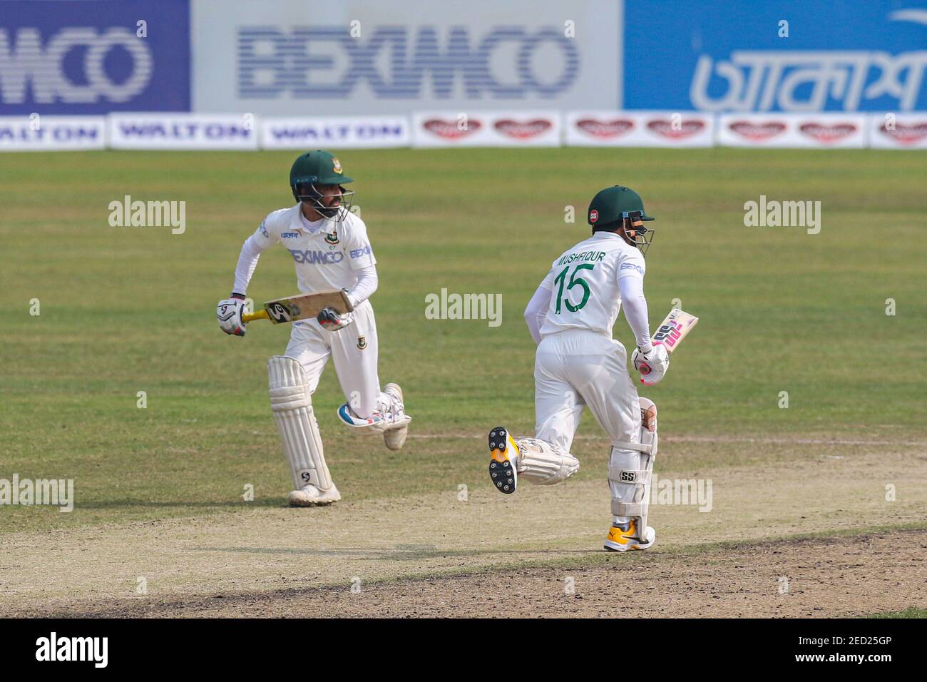 Bangladesh's Mushfiqur Rahim (R) and Mominul Haque (L) run between the wickets during the fourth day of the second Test cricket match between West Indies and Bangladesh at the Sher-e-Bangla National Cricket Stadium in Dhaka. Stock Photo