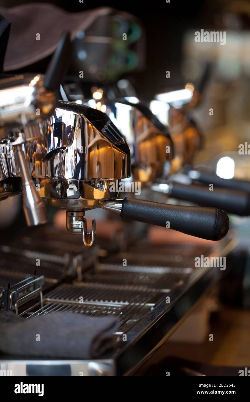 closeup of holders in professional 3 group head espresso coffee machine, blurred background, no people Stock Photo