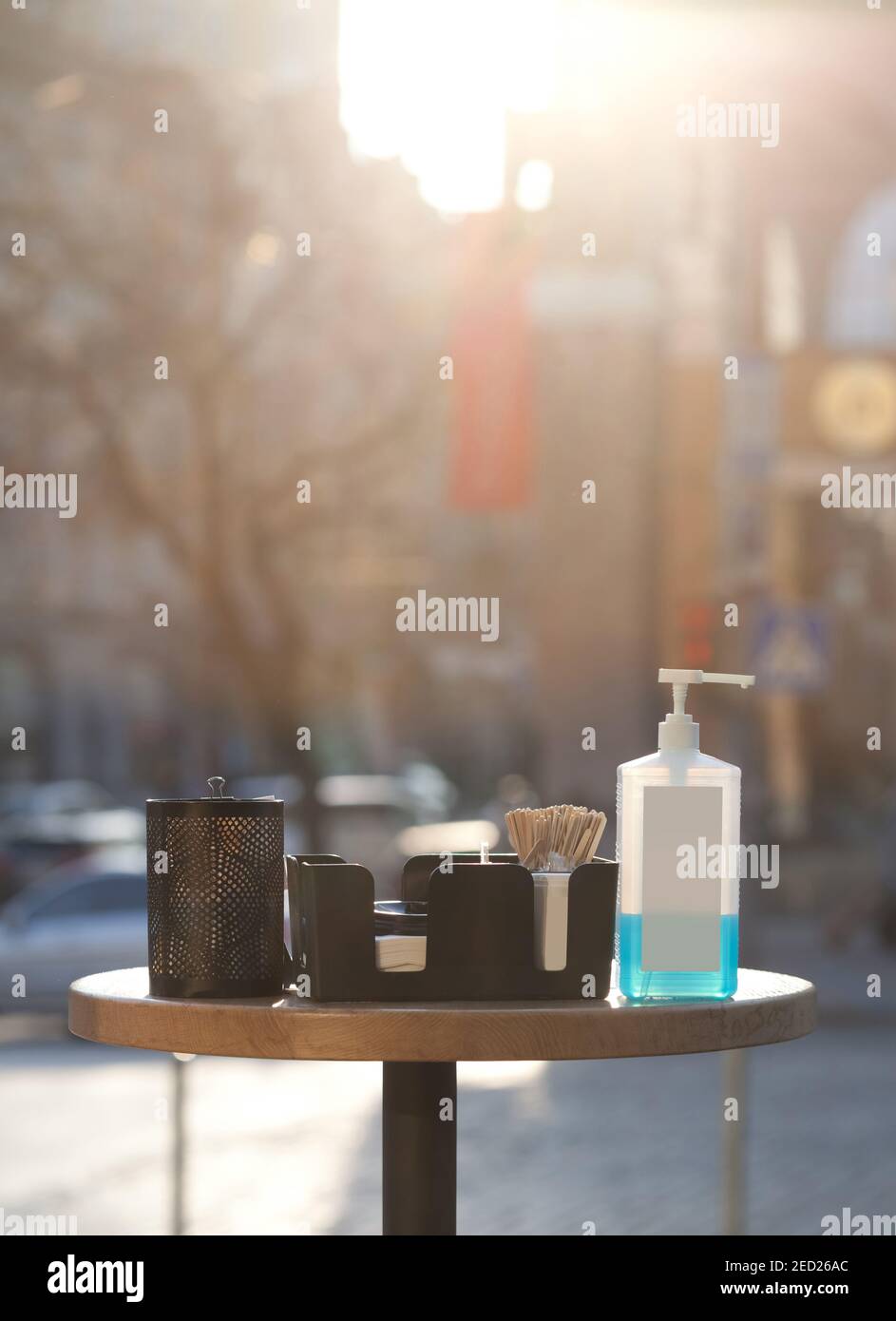 safety measures during covid 19 quarantine - table with sanitizer in public place in front of coffee shop Stock Photo