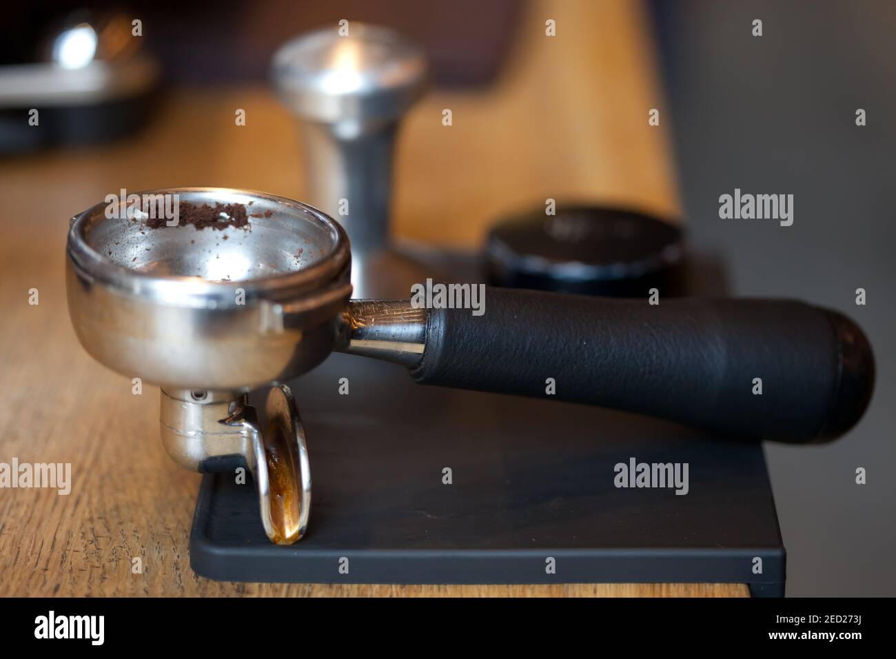 espresso machine holder on rubber pad at table in coffee shop, macro, nobody Stock Photo