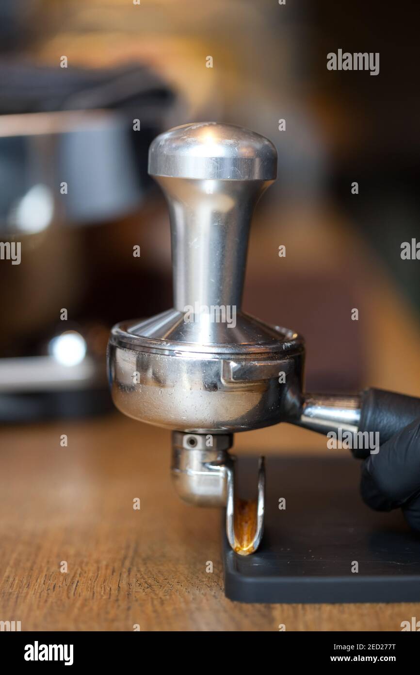 temper in espresso coffee holder on table in coffee shop, closeup, nobody Stock Photo