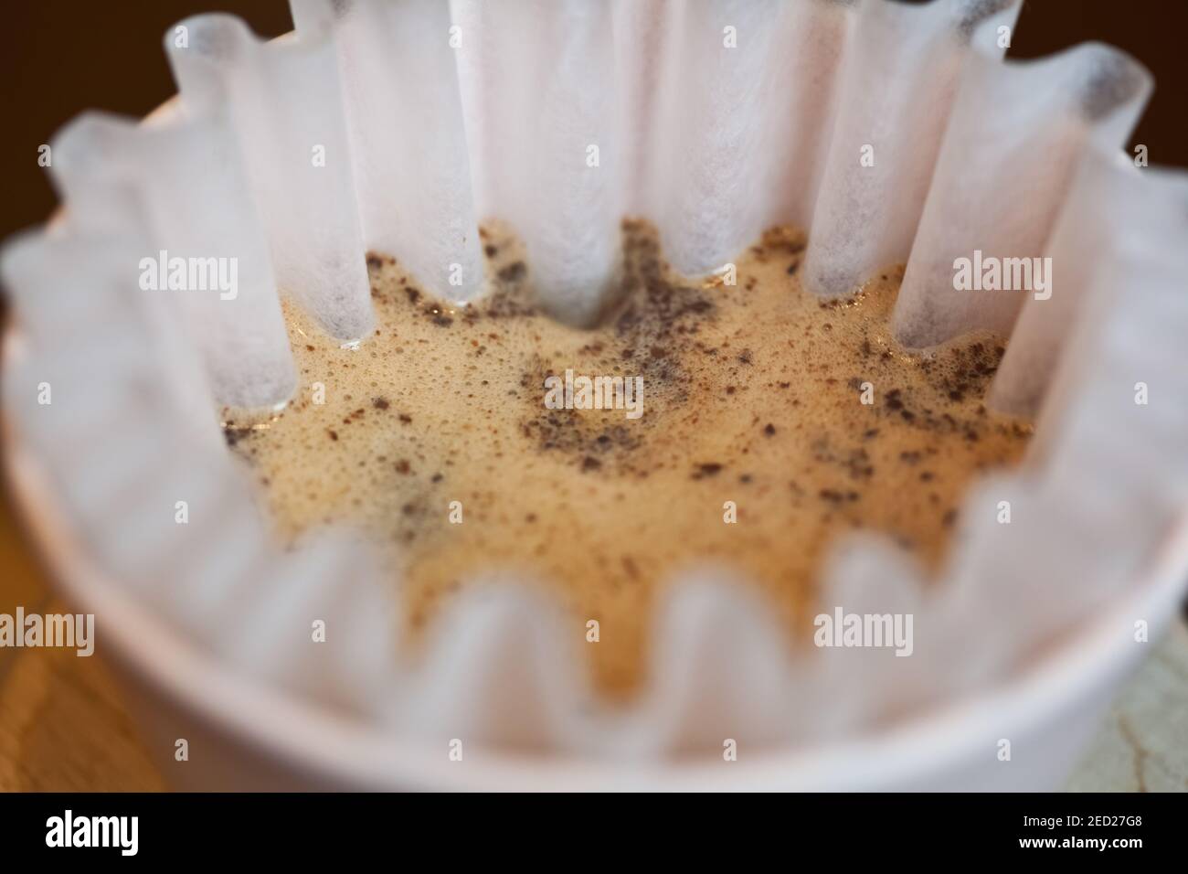 closeup of coffee brewing in pour over with kalita paper filter Stock Photo