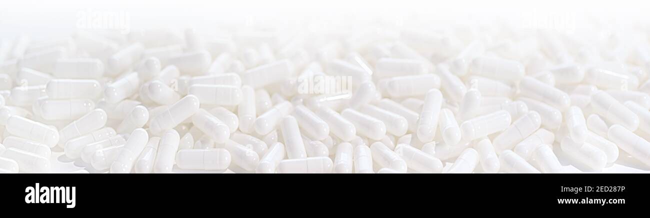 Long panoramic background with whites medical capsules. Selective focus Stock Photo