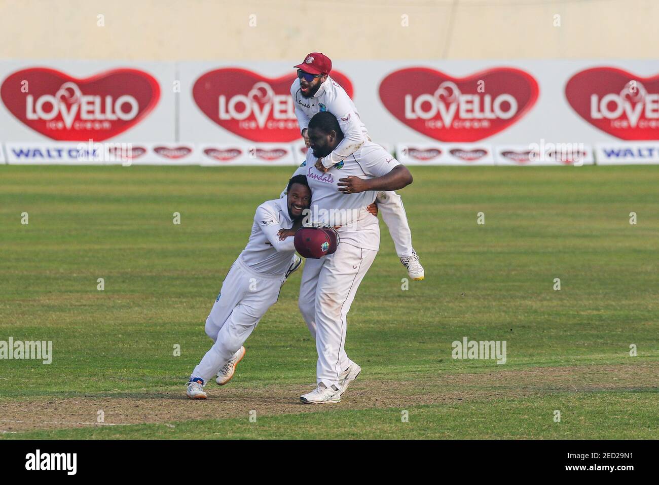 West Indies John Campbell (top) with his teammates Rahkeem Cornwall (R) and Shayne Moseley celebrate the dismissal of Bangladeshs Liton Das (not pictured) during the fourth day of the second Test cricket