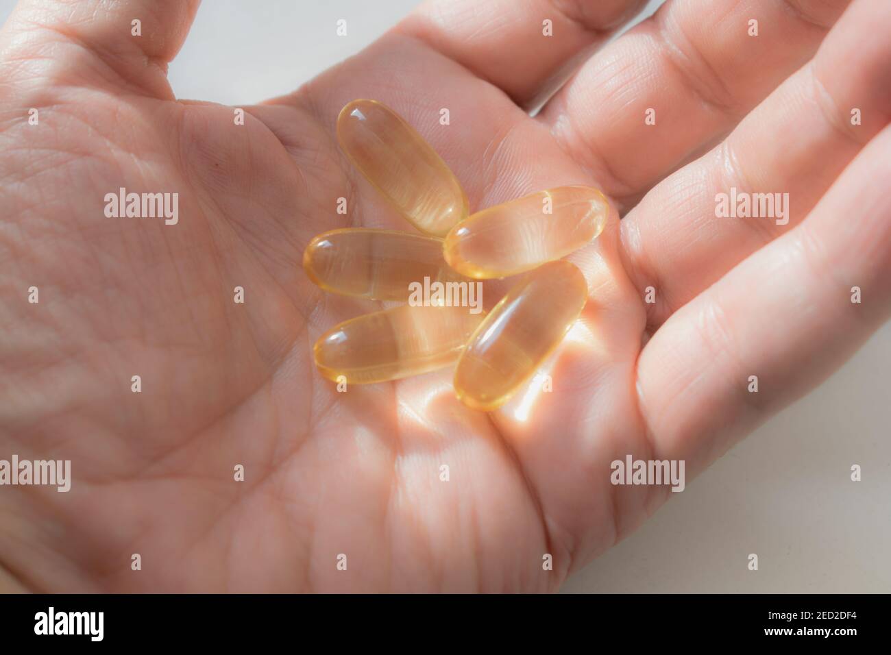 Fish oil tablets in the palm of your hand Stock Photo Alamy