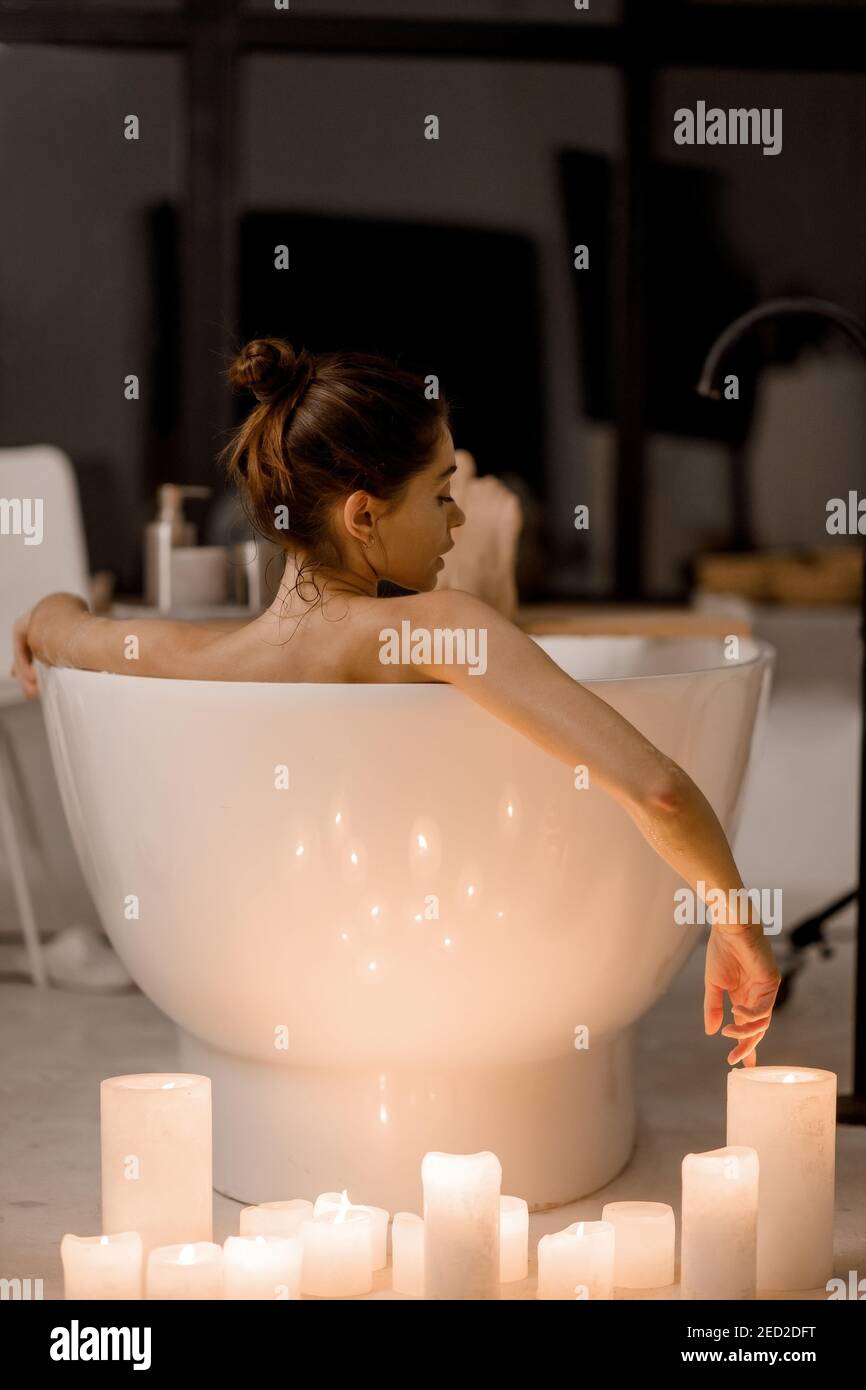 https://c8.alamy.com/comp/2ED2DFT/young-woman-relaxing-in-the-beautiful-vintage-bath-full-of-foam-in-the-retro-bathroom-decorated-with-candles-2ED2DFT.jpg