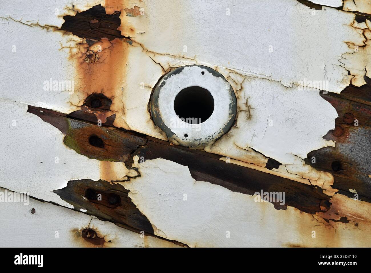 Close up detail of section of boat hull with circular hole and extreme
