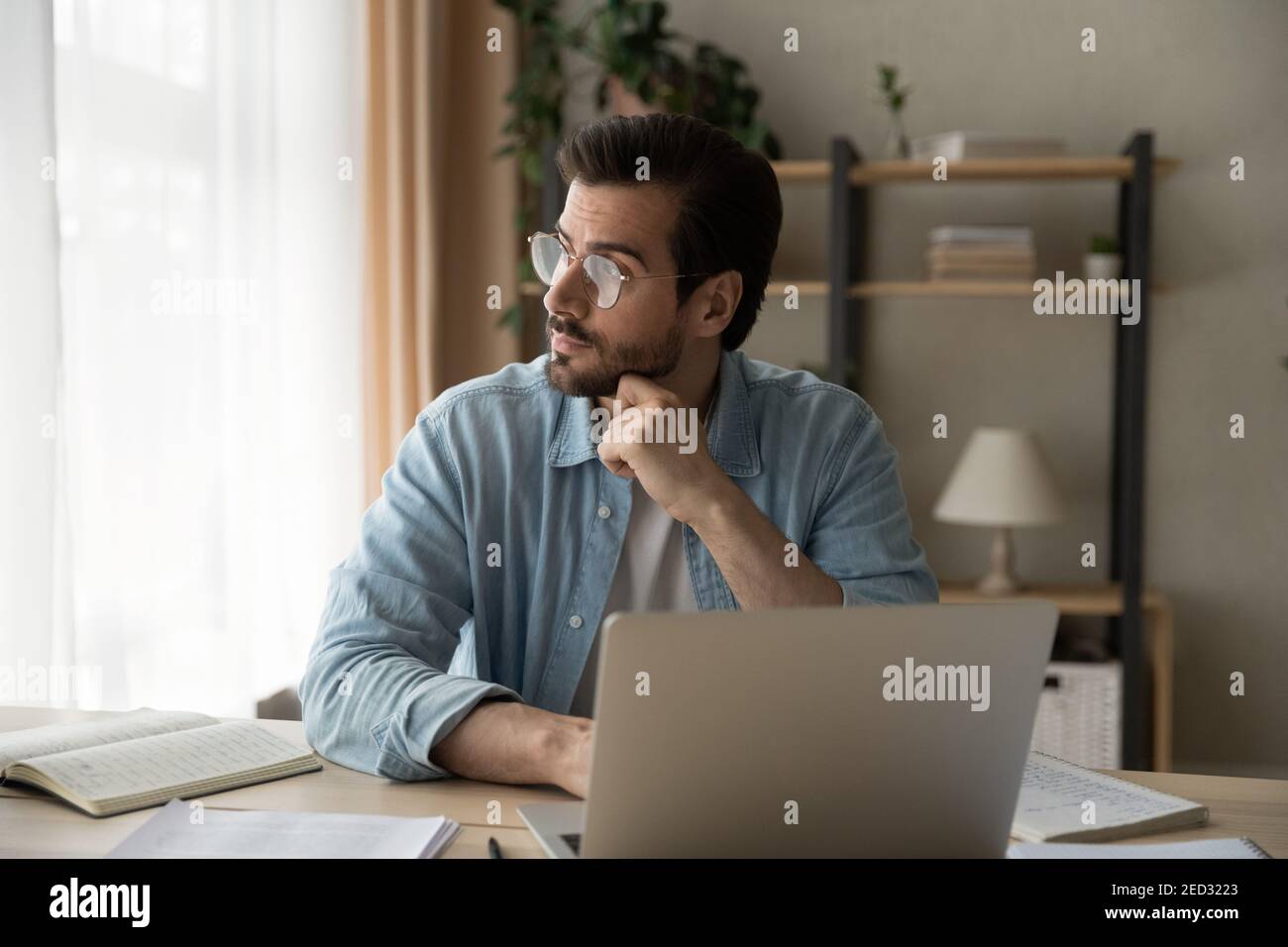 Thoughtful businessman analyze information in mind distracted from laptop screen Stock Photo