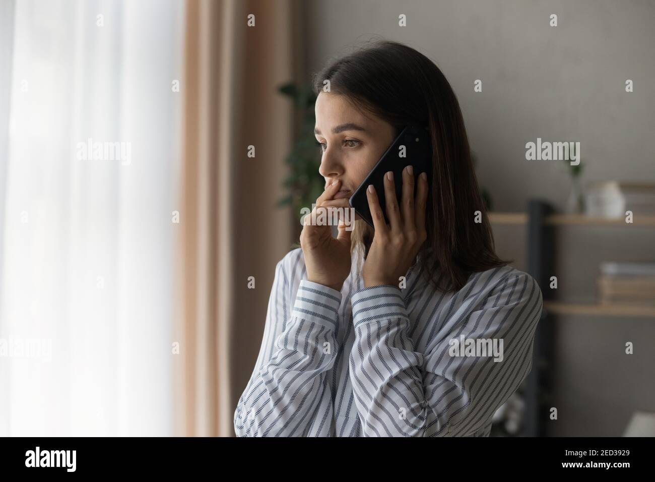 Sad compassionate young lady support friend in phone talk Stock Photo