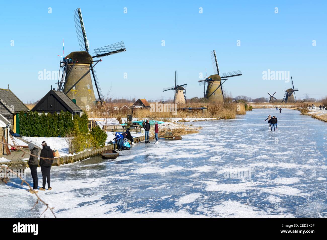 Ice skating between the windmills of Kinderdijk in the winter of 2021. The Netherlands Stock Photo
