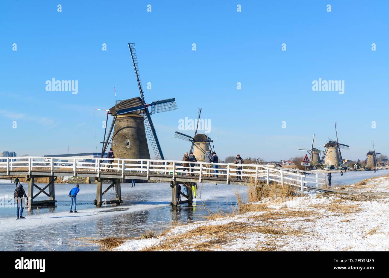 Ice skating between the windmills of Kinderdijk in the winter of 2021. The Netherlands Stock Photo