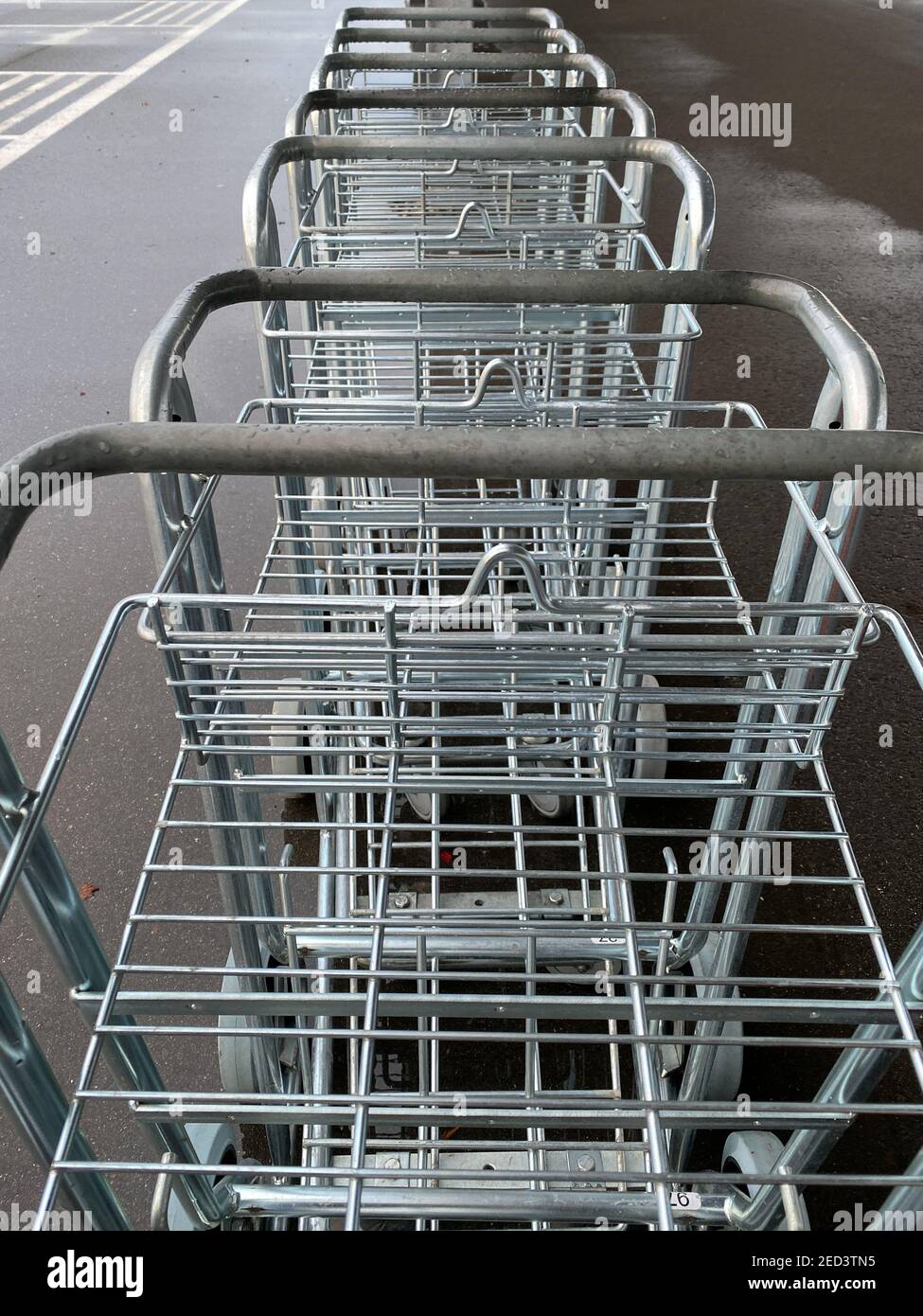 empty luggage carts in a row at the airport Stock Photo Alamy