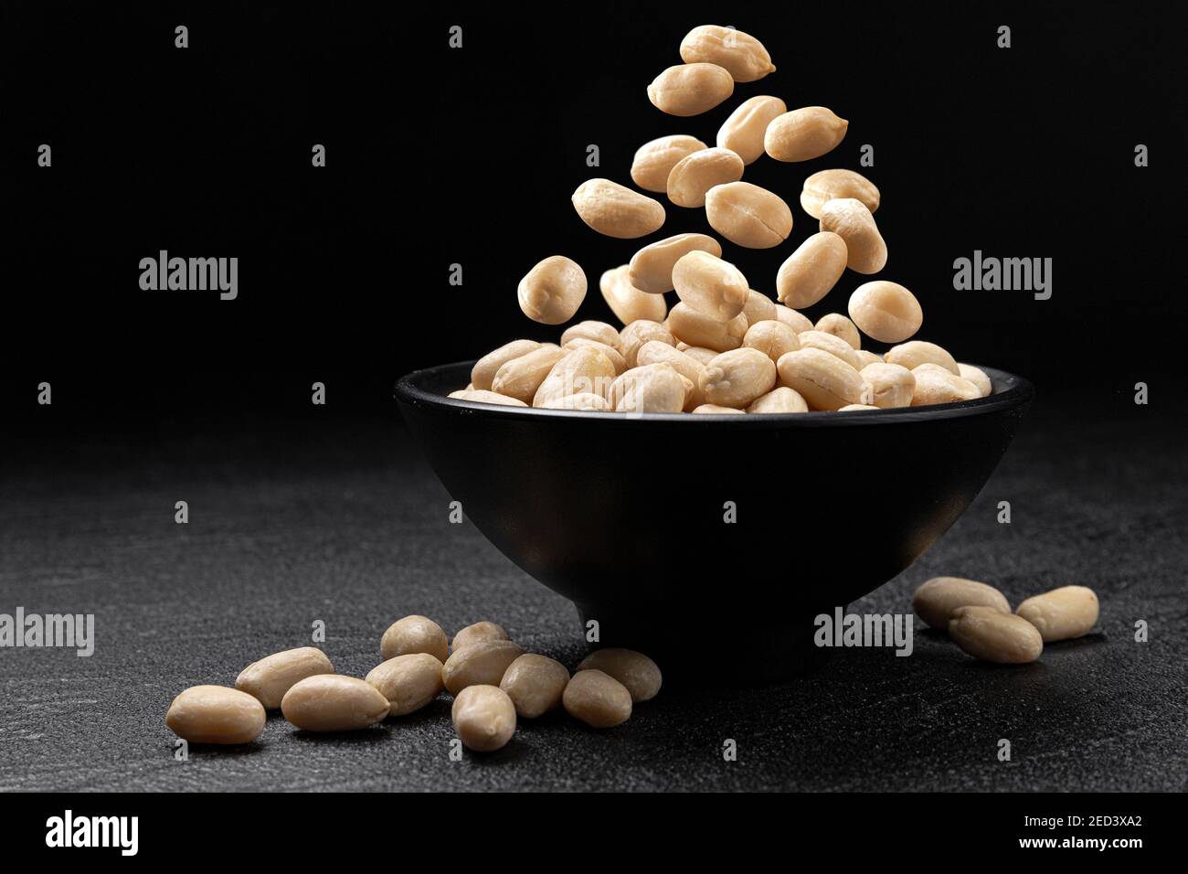 Falling peanut on black background with copy space Stock Photo