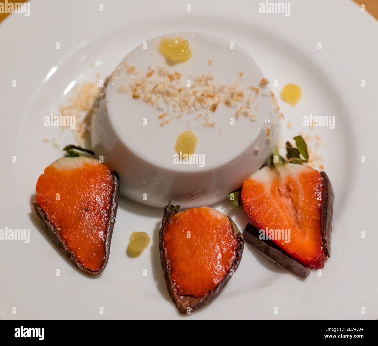 Fine dining dessert plate: coconut panna cotta, pineapple gel and chocolate dipped strawberries by chef Paul Wedgwood, Scotland, UK Stock Photo