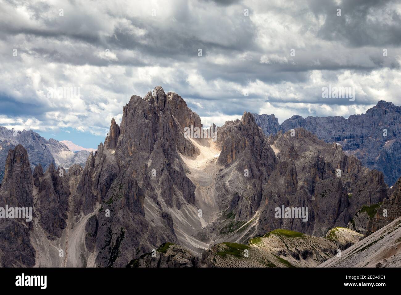 Sunlight and cloudy dramatic sky  Cadini di Misurina mountain group. Sexten Dolomites. Misurina, Veneto. Italian Alps. Europe. Stock Photo