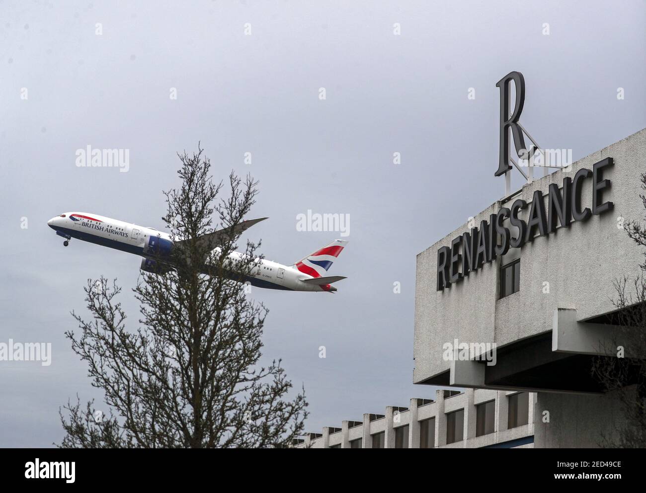 A plane flies over the Renaissance Hotel near Heathrow Airport, London. From Monday UK nationals or residents returning to England from 33 'red list' countries will be required to spend 10 days in a Government-designated quarantine hotel upon arrival. Picture date: Sunday February 14, 2021. Stock Photo