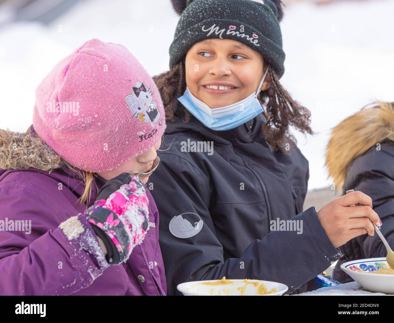 Helsinki Finland 14 February 2021. Company of children eating soup on the street. High quality photo Stock Photo