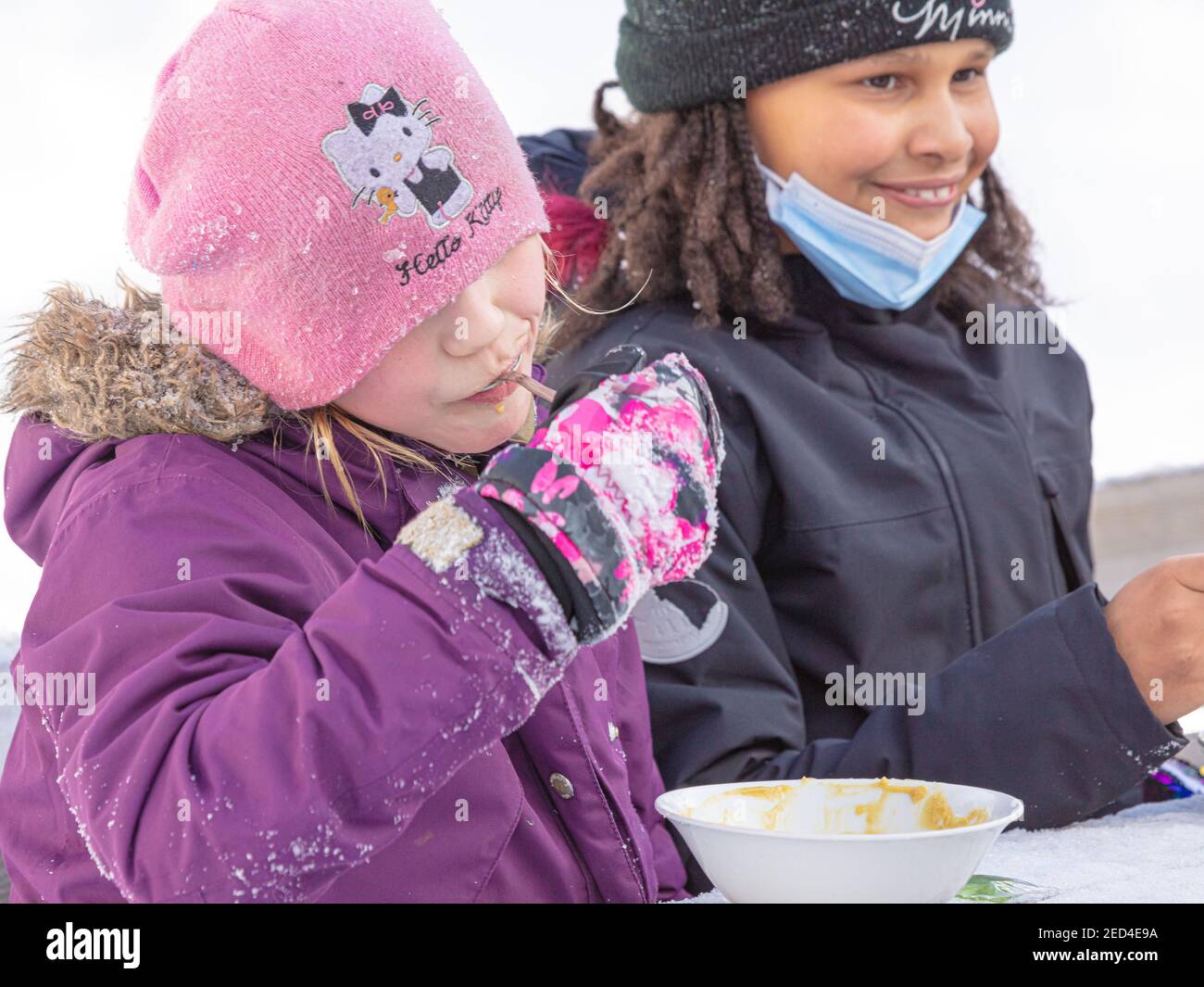 Helsinki Finland 14 February 2021. Company of children eating soup on the street. High quality photo Stock Photo