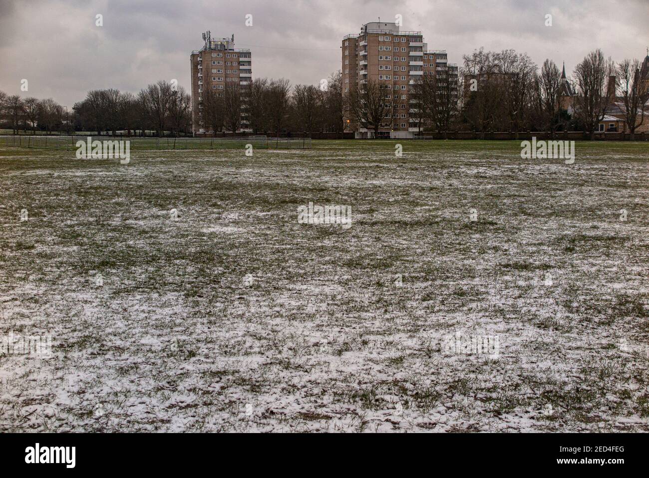 Blocks of flats and a snowy park on a grey day Stock Photo Alamy