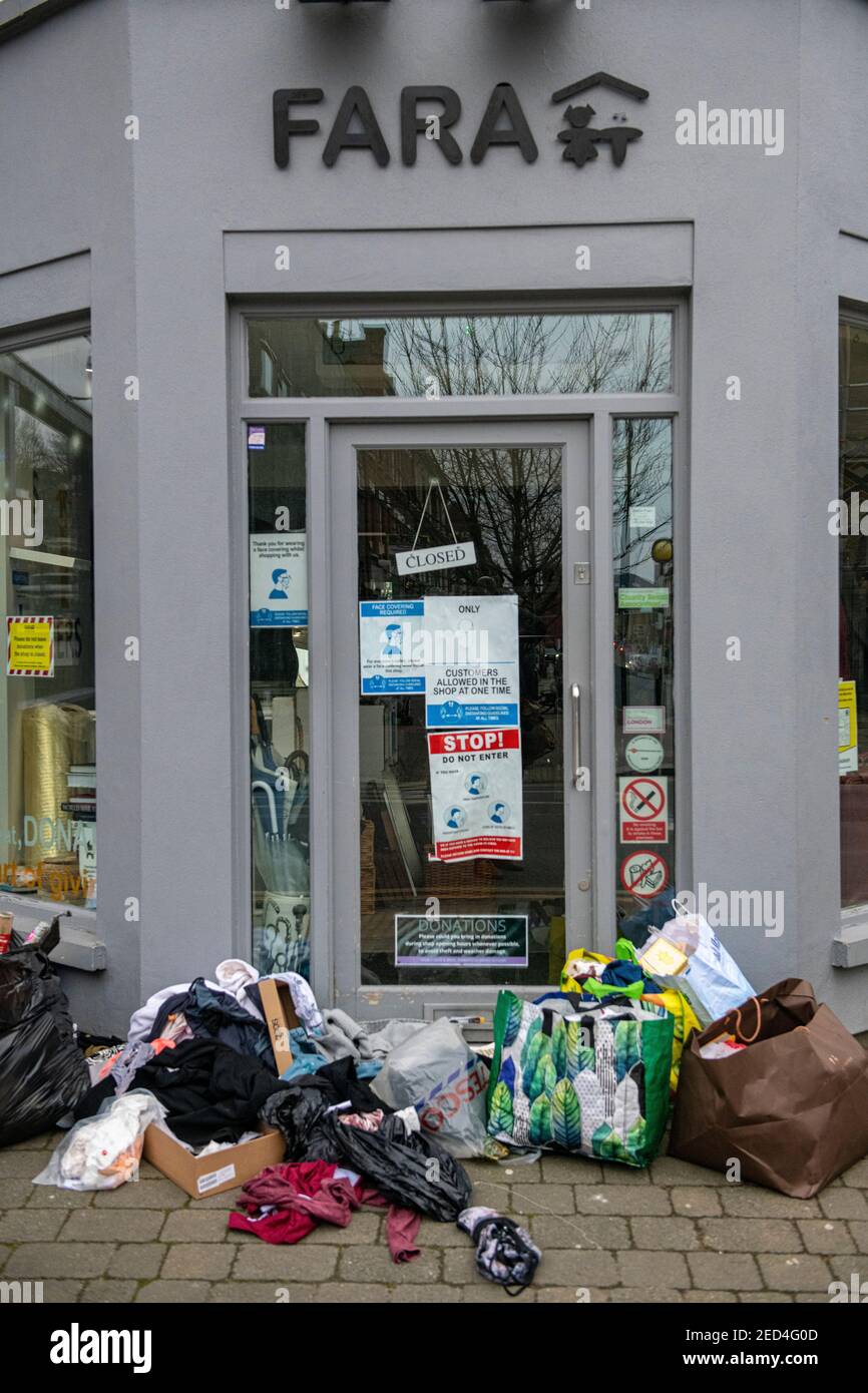 2021 lockdown and bags left outside closed charity shops are ripped open and their contets taken