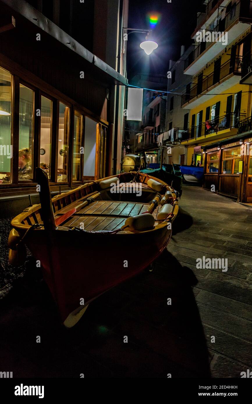 Night in a very colorful seacoast village street scene, with fishing boat dominant in the foreground, Cinque Terre, Stock Photo