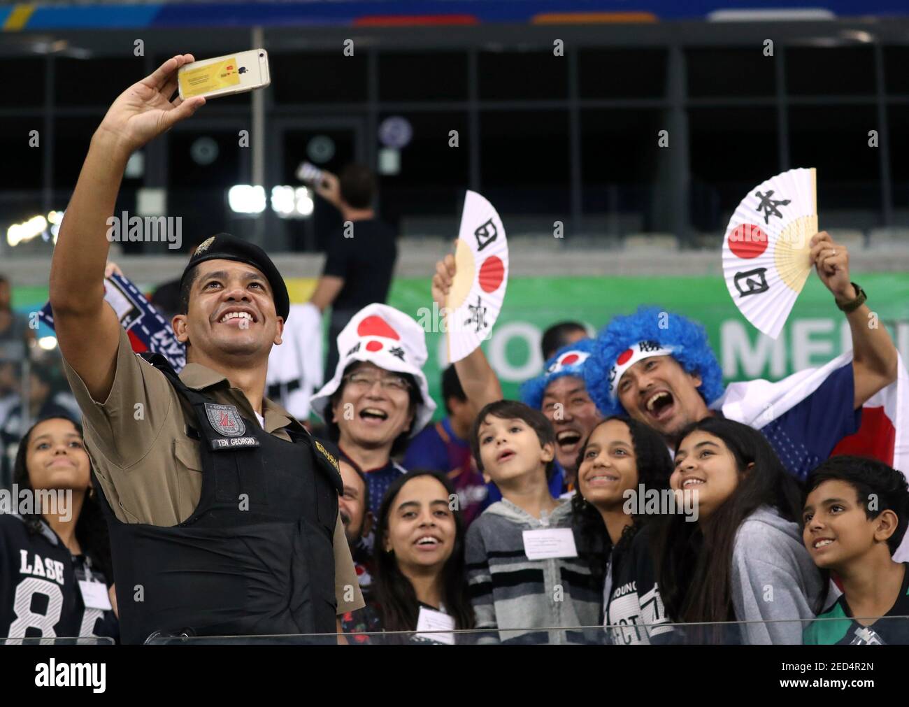 Soccer Football - Copa America Brazil 2019 - Group C - Ecuador v Japan - Mineirao Stadium, Belo Horizonte, Brazil - June 24, 2019   General view of a police office taking a selfie with Japan fans before the match   REUTERS/Edgard Garrido Stock Photo
