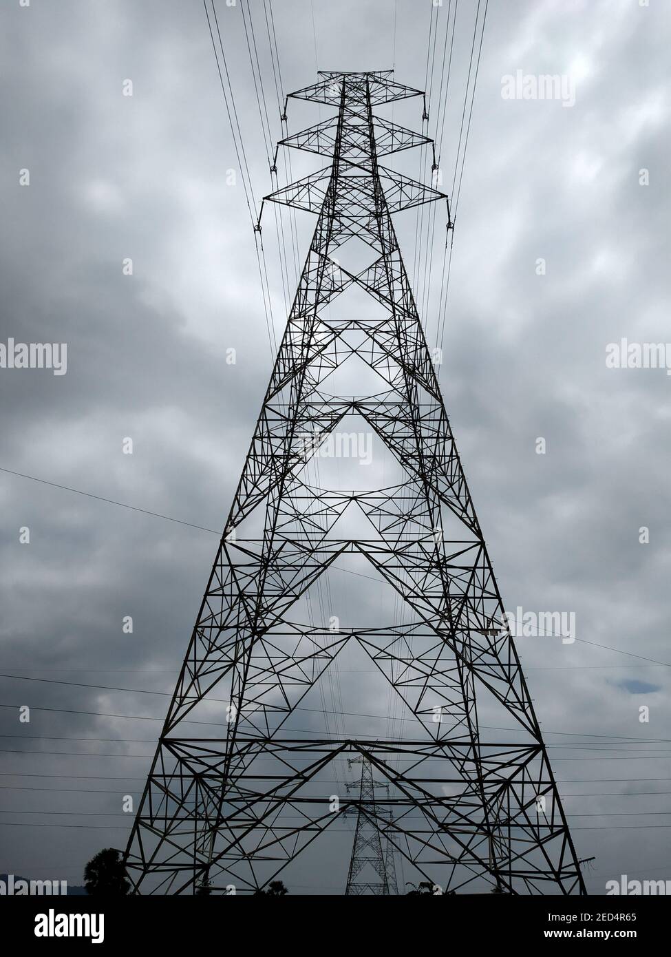 A vertical shot of a transmission tower during the cloudy day Stock ...