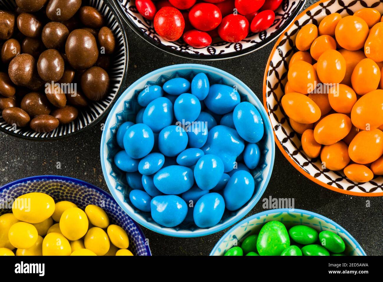 M&M's candy on the black background in bowls, colorful candy and ...