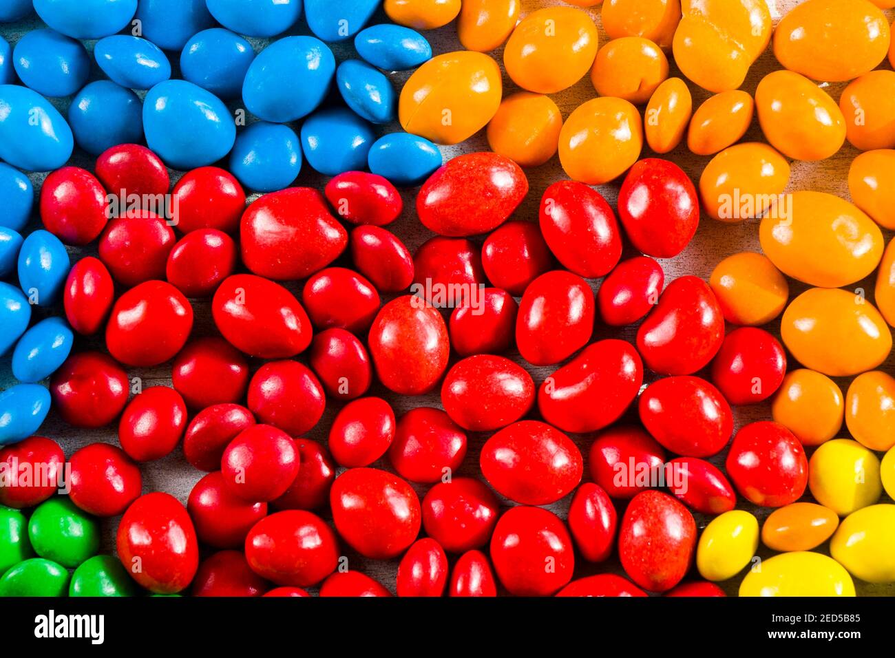 M&M's candy on the yellow background, colorful candy and multicolored ...